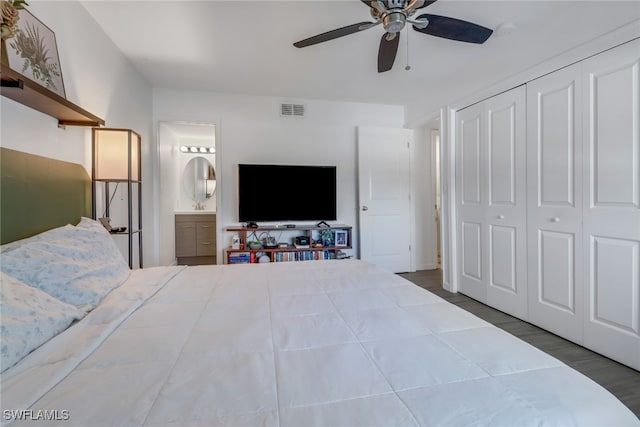 bedroom featuring dark wood-type flooring, a closet, ensuite bath, and ceiling fan