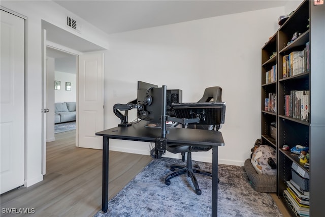 home office with hardwood / wood-style flooring