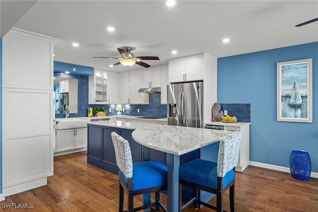 kitchen featuring white cabinets, a kitchen island, and stainless steel refrigerator with ice dispenser