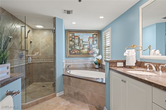 bathroom with vanity and independent shower and bath