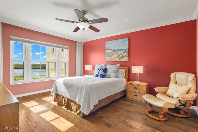 bedroom with hardwood / wood-style flooring, ceiling fan, and ornamental molding