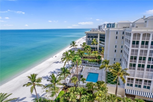 bird's eye view featuring a water view and a beach view