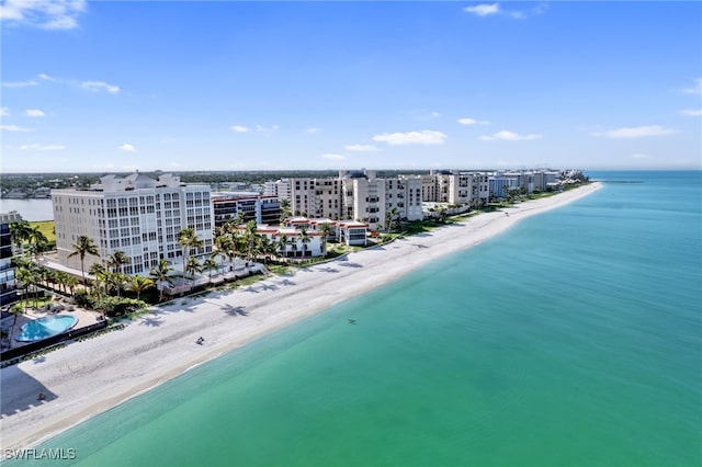 aerial view with a water view and a beach view