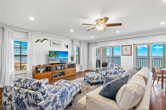 living room with ceiling fan, wood-type flooring, and crown molding