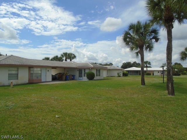 rear view of property featuring a lawn