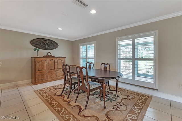 tiled dining area featuring ornamental molding