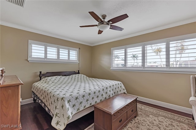 bedroom with crown molding, hardwood / wood-style floors, and ceiling fan