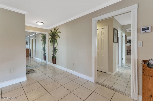 unfurnished room with ornamental molding and light tile patterned floors