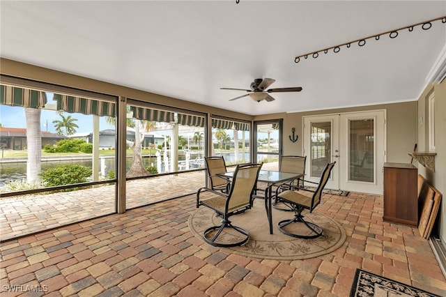 sunroom / solarium with french doors and ceiling fan