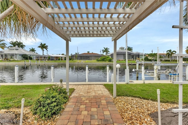 exterior space featuring a pergola, a water view, and a yard