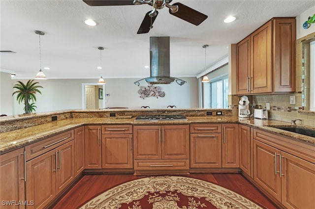 kitchen featuring island range hood, ceiling fan, dark hardwood / wood-style flooring, and light stone counters