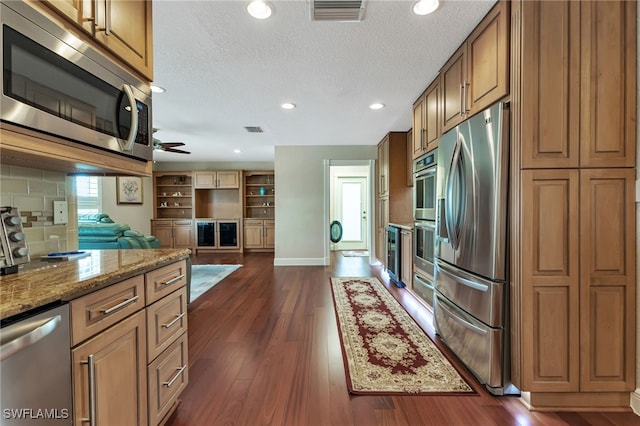 kitchen with ceiling fan, tasteful backsplash, dark hardwood / wood-style flooring, and stainless steel appliances