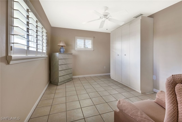 tiled bedroom with ceiling fan