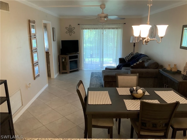 tiled dining space with ceiling fan with notable chandelier and crown molding