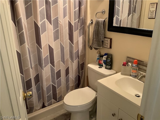 bathroom featuring tile patterned floors, a shower with curtain, toilet, and vanity