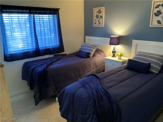 bedroom with light tile patterned floors