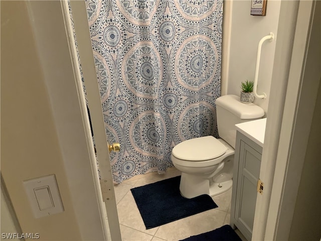 bathroom with vanity, tile patterned flooring, and toilet