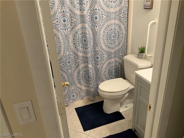 bathroom featuring vanity, tile patterned floors, and toilet