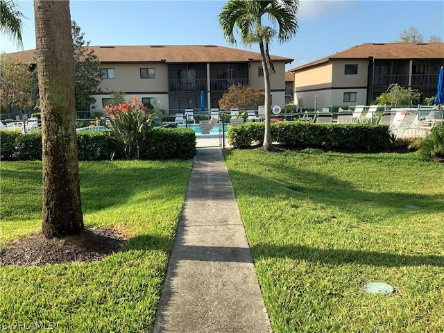 surrounding community featuring a yard and a swimming pool