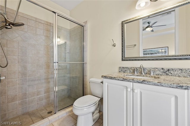 bathroom featuring ceiling fan, vanity, toilet, and an enclosed shower