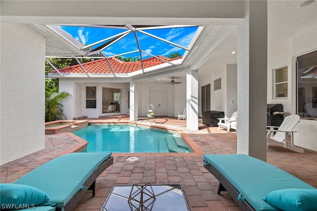 view of swimming pool featuring a lanai, a patio, ceiling fan, and an in ground hot tub