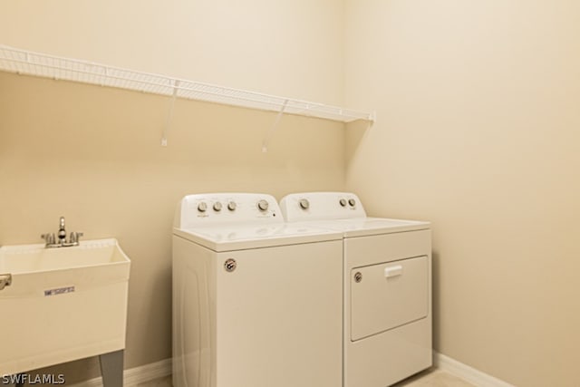 laundry area with sink and washing machine and clothes dryer