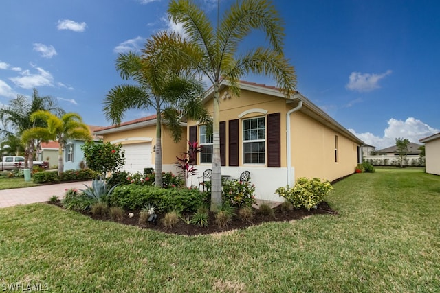 view of front of house with a garage and a front yard