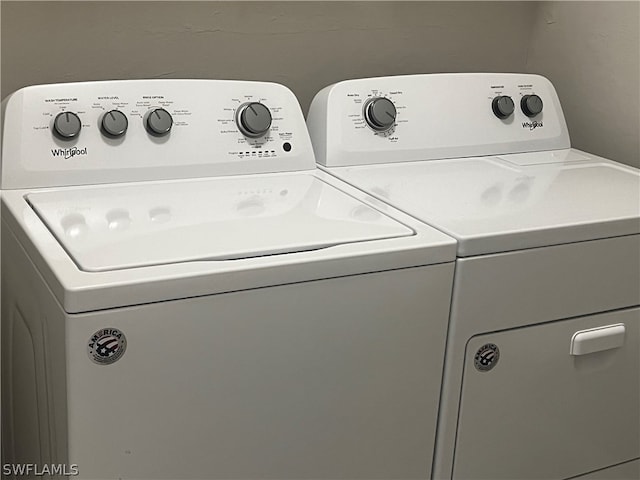 clothes washing area with separate washer and dryer