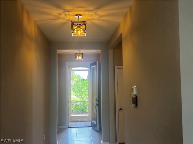 doorway to outside with light tile patterned flooring