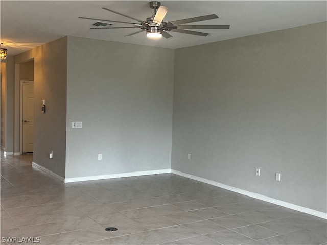 tiled empty room featuring ceiling fan