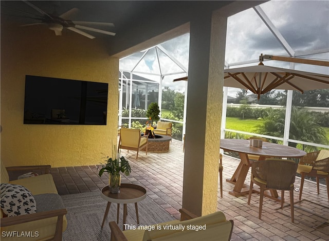 sunroom featuring ceiling fan