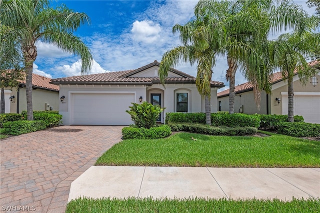 mediterranean / spanish-style home with a garage