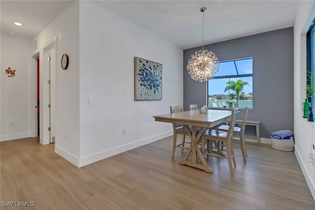 dining area featuring hardwood / wood-style flooring and a chandelier