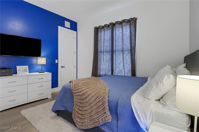 bedroom with wood-type flooring