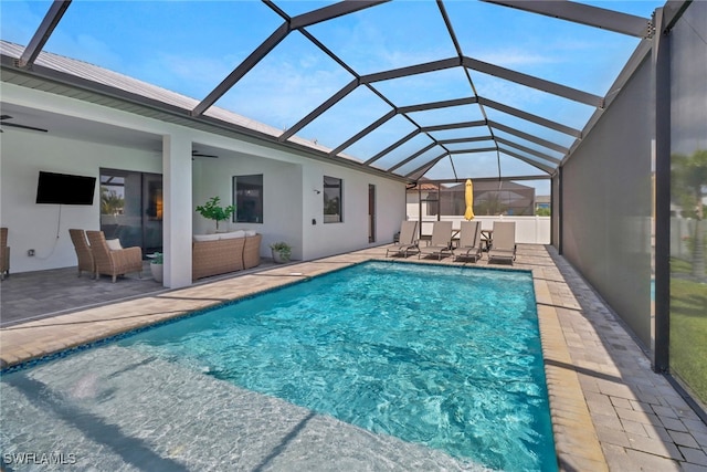 view of swimming pool featuring a patio, an outdoor hangout area, a lanai, and ceiling fan