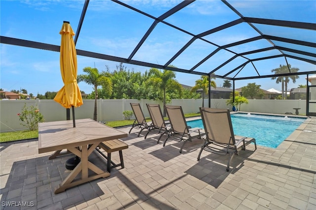 view of pool with a patio and glass enclosure