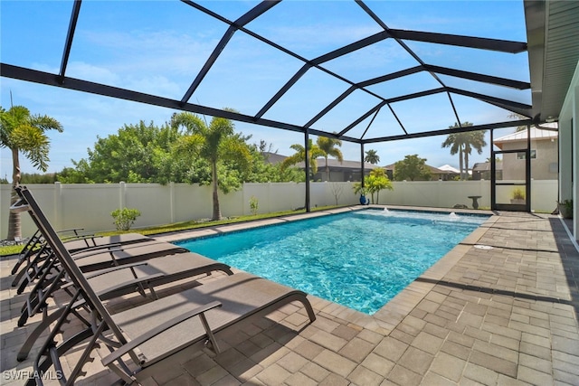 view of pool featuring a lanai, pool water feature, and a patio