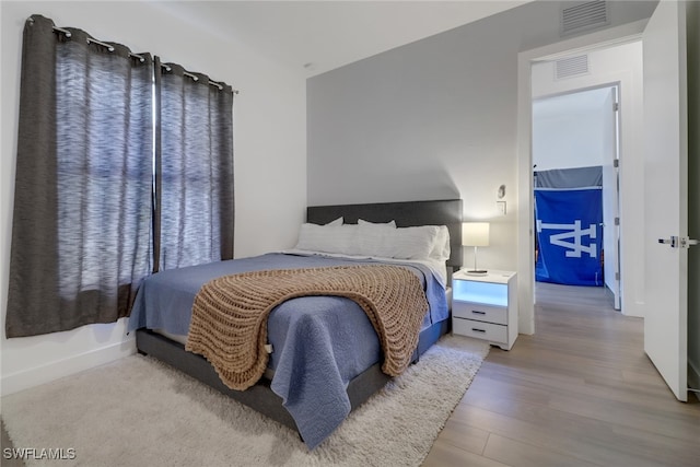 bedroom with hardwood / wood-style floors