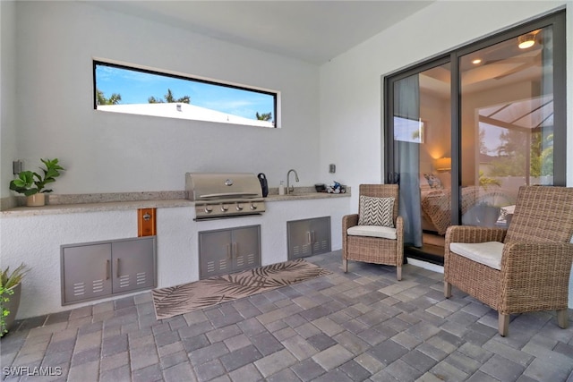 view of patio featuring area for grilling and sink