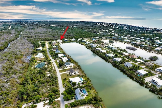 birds eye view of property featuring a water view