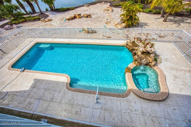 view of swimming pool with a patio and an in ground hot tub