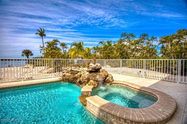 view of pool featuring an in ground hot tub and pool water feature