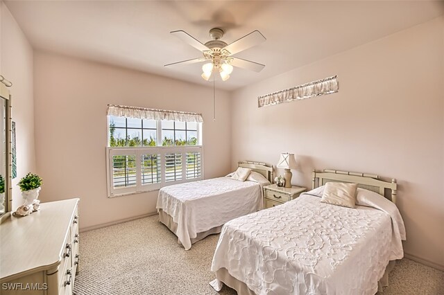 bedroom featuring light carpet and ceiling fan