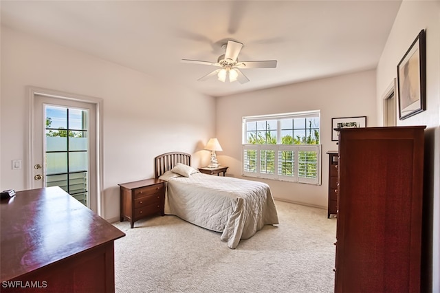 bedroom with multiple windows, light carpet, ceiling fan, and access to outside