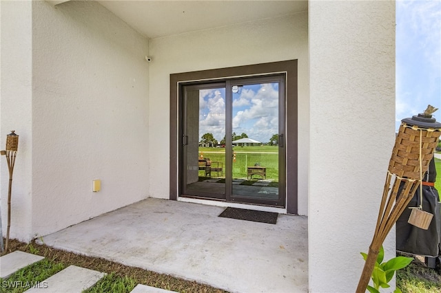 property entrance featuring a patio