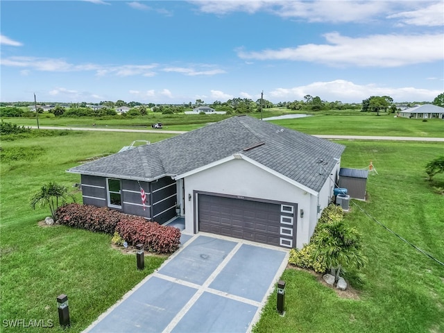 ranch-style house with a garage, central air condition unit, and a front lawn