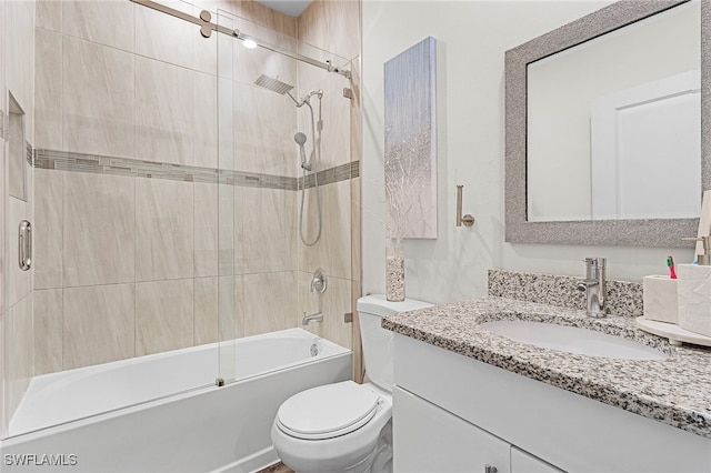 full bathroom featuring vanity, shower / bath combination with glass door, and toilet