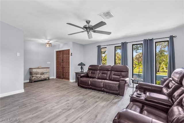 living room with ceiling fan and light hardwood / wood-style floors