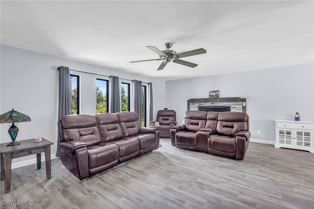 living room with ceiling fan and light hardwood / wood-style floors