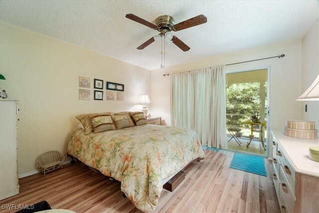 bedroom with ceiling fan, light hardwood / wood-style floors, a textured ceiling, and access to outside